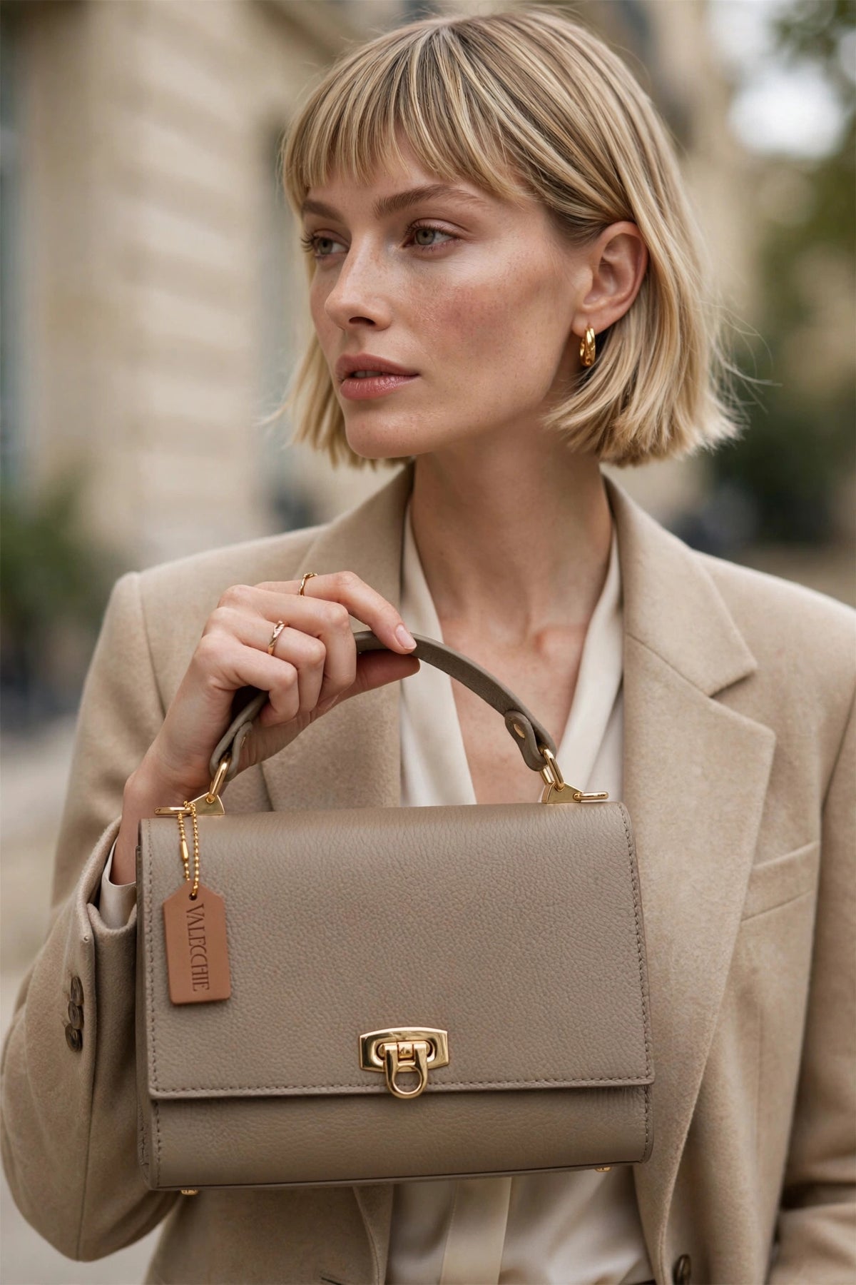 Model holding the Lil Valecchie in taupe